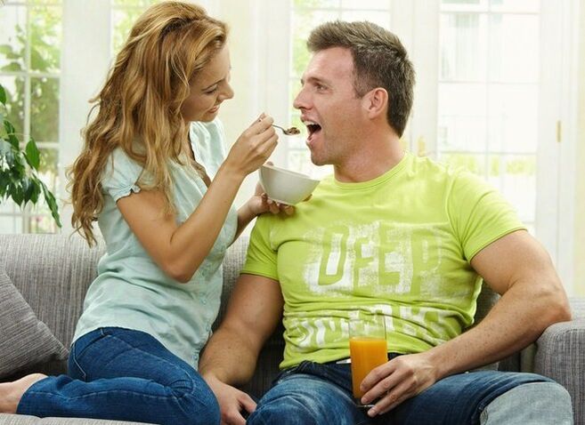 the woman feeds the man products to increase potency