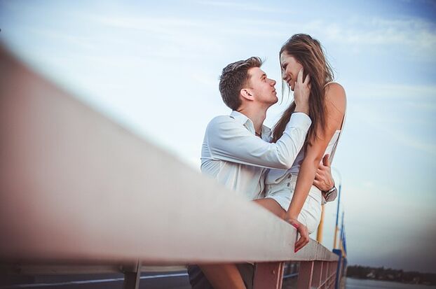 A woman in the arms of a man with excellent potency